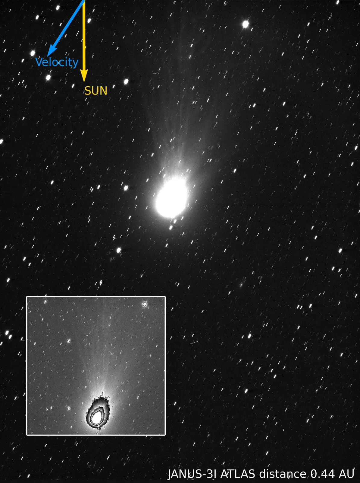 A grainy spacecraft image of a comet with a bright coma and a long faint tail