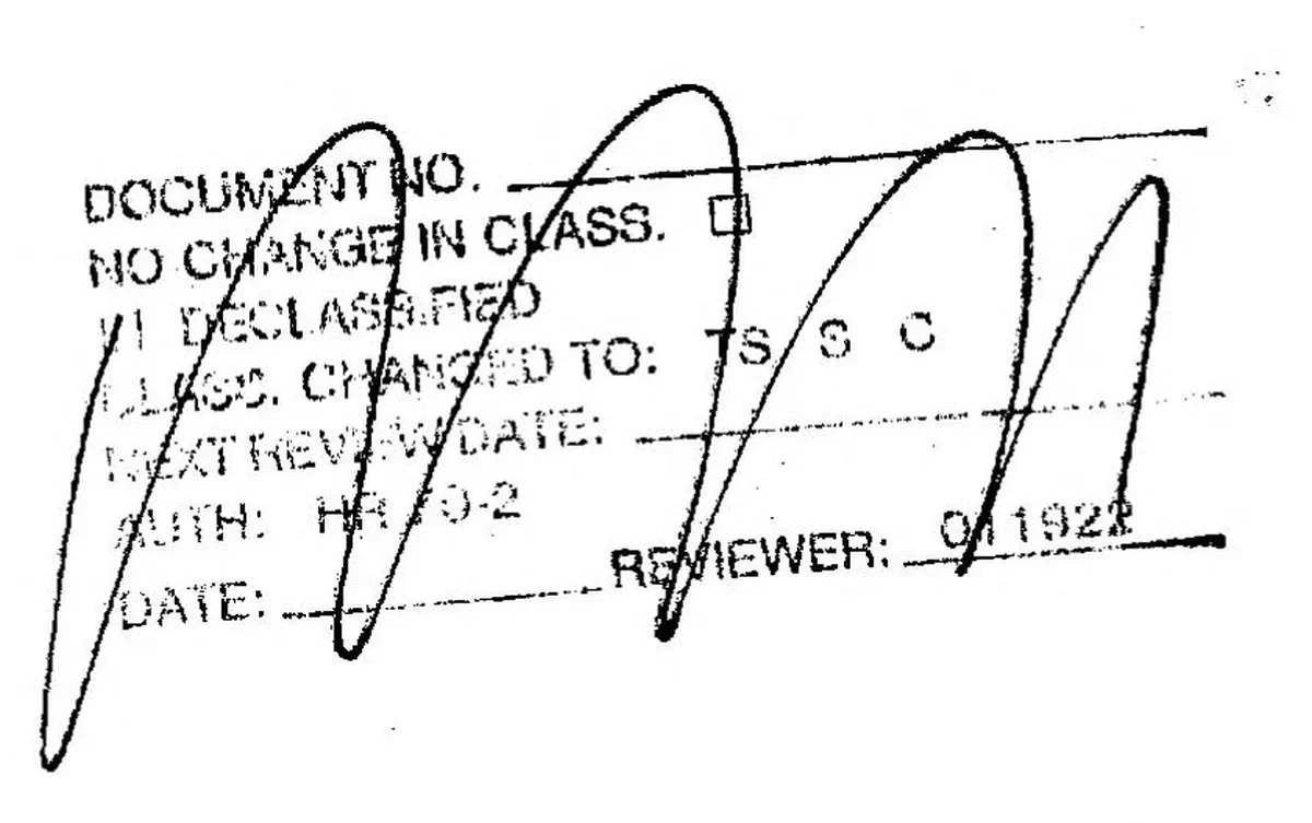 A rubber review stamp on the cover with lines for document number, class and reviewer, overwritten by large pen loops.