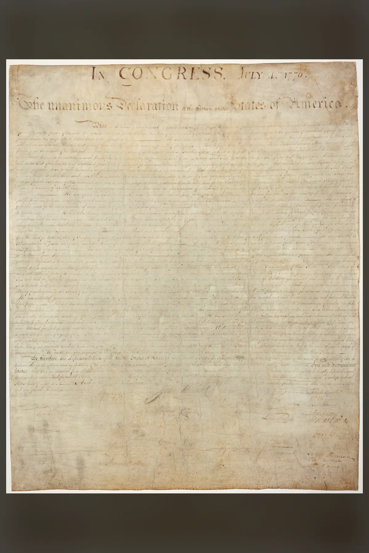The parchment Declaration of Independence, heavily faded, its heading still legible.