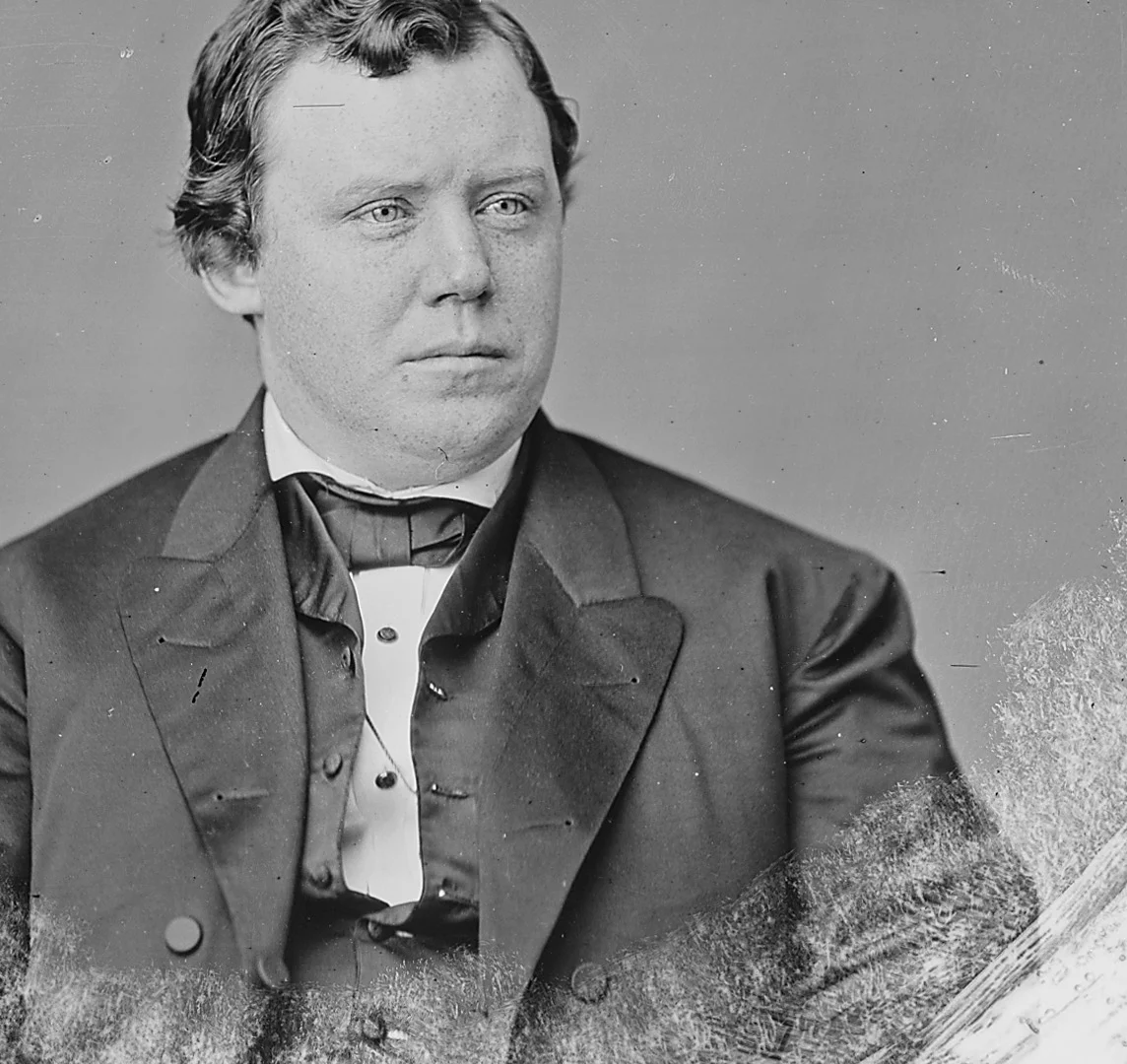 Ignatius Donnelly as a young congressman in the 1860s, seated, in a dark coat and bow tie.