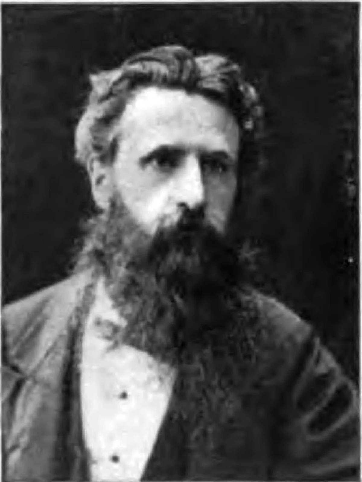 A black and white portrait photograph of George Smith, a bearded man in a dark coat.