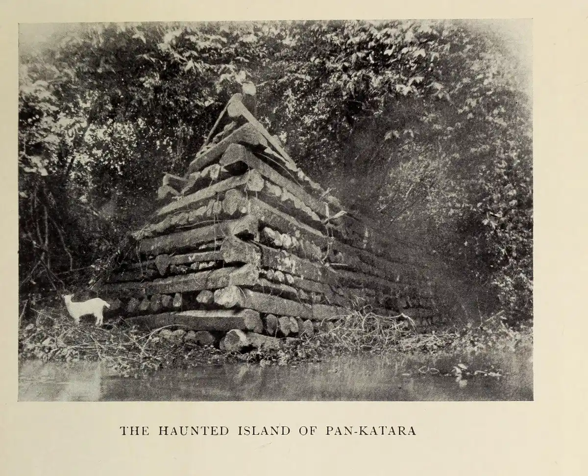 A black and white 1895 photograph of a stepped corner of stacked stone in dense forest, printed with the title The Haunted Island of Pan-Katara.