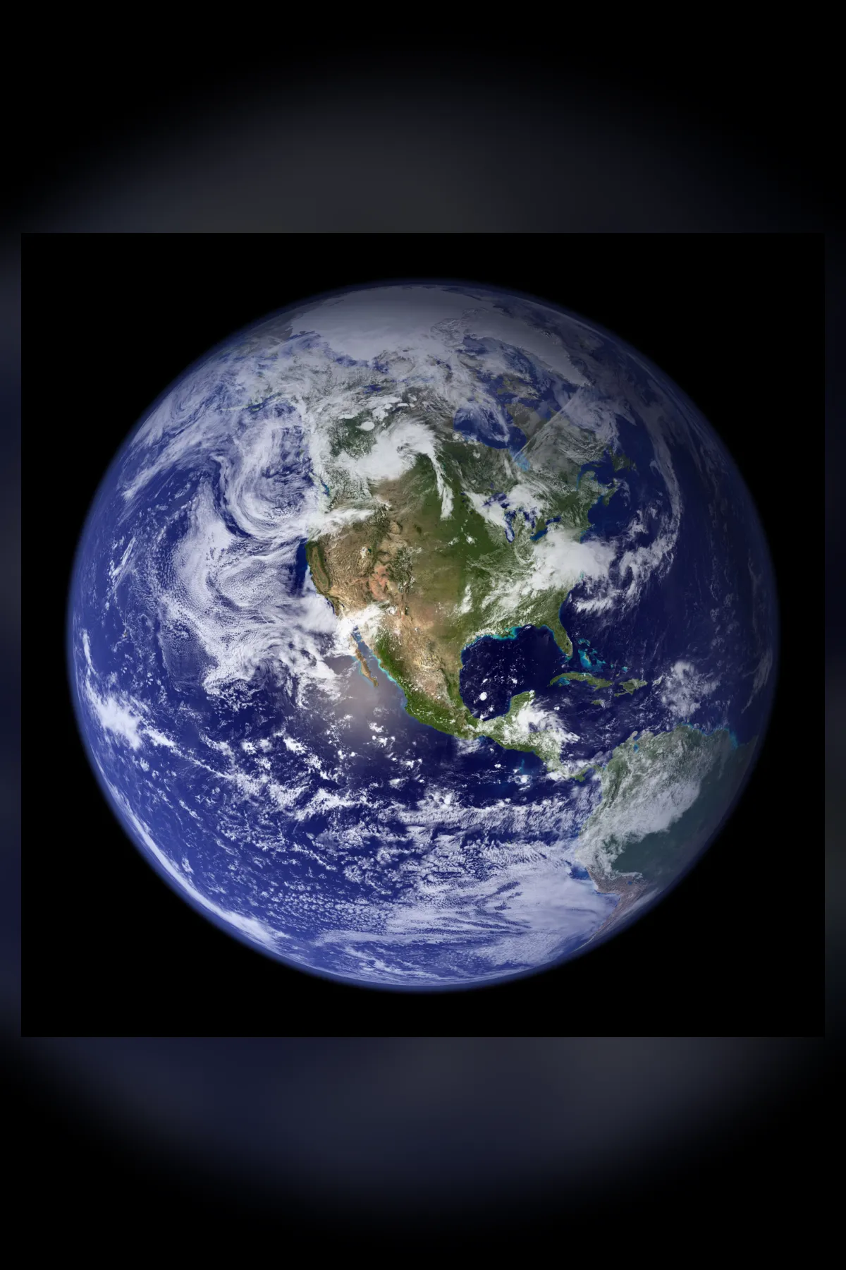 A whole Earth on black, centred on North America, with bright swirling cloud and a deep blue ocean.