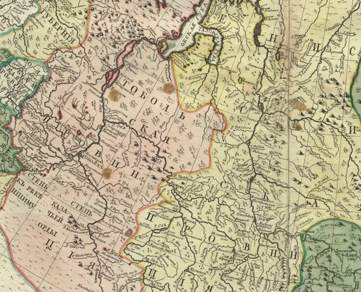 A detail of a hand-coloured map with the Russian words for Tobolsk province in large spaced letters across a pink region, rivers and small mountain marks.