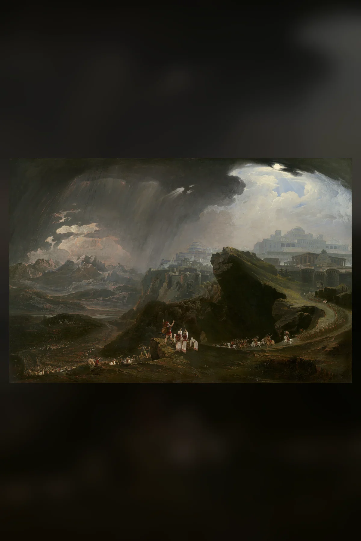 John Martin's painting of a small army winding along a rocky road through a vast landscape, under a storm that breaks open on a shaft of light