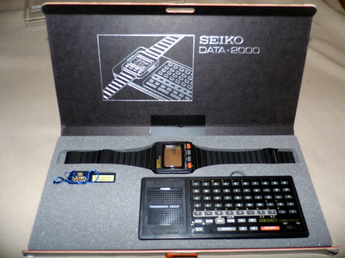 A boxed digital wristwatch laid out above a small keyboard dock, with the lid printed Seiko Data-2000.