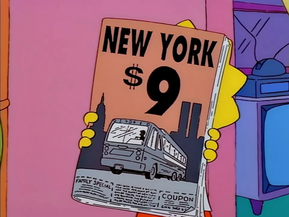 Lisa holding up a folded leaflet reading New York, $9, with a bus and tall towers.
