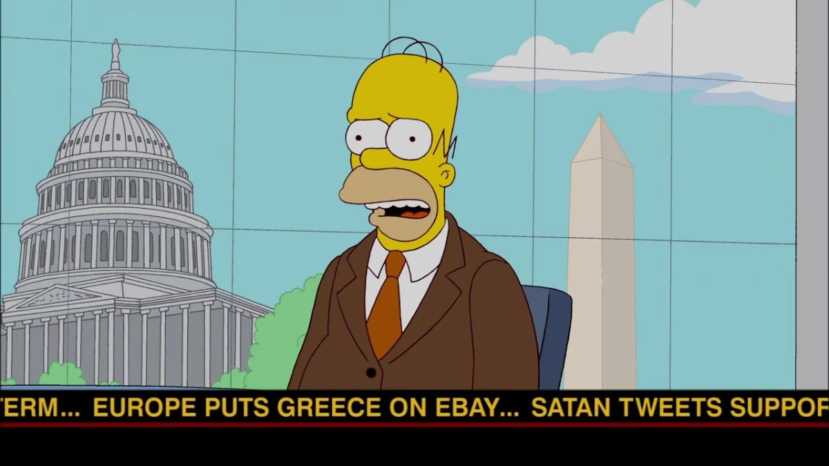 Homer in a brown suit on a news set, a ticker along the foot reading Europe puts Greece on eBay.