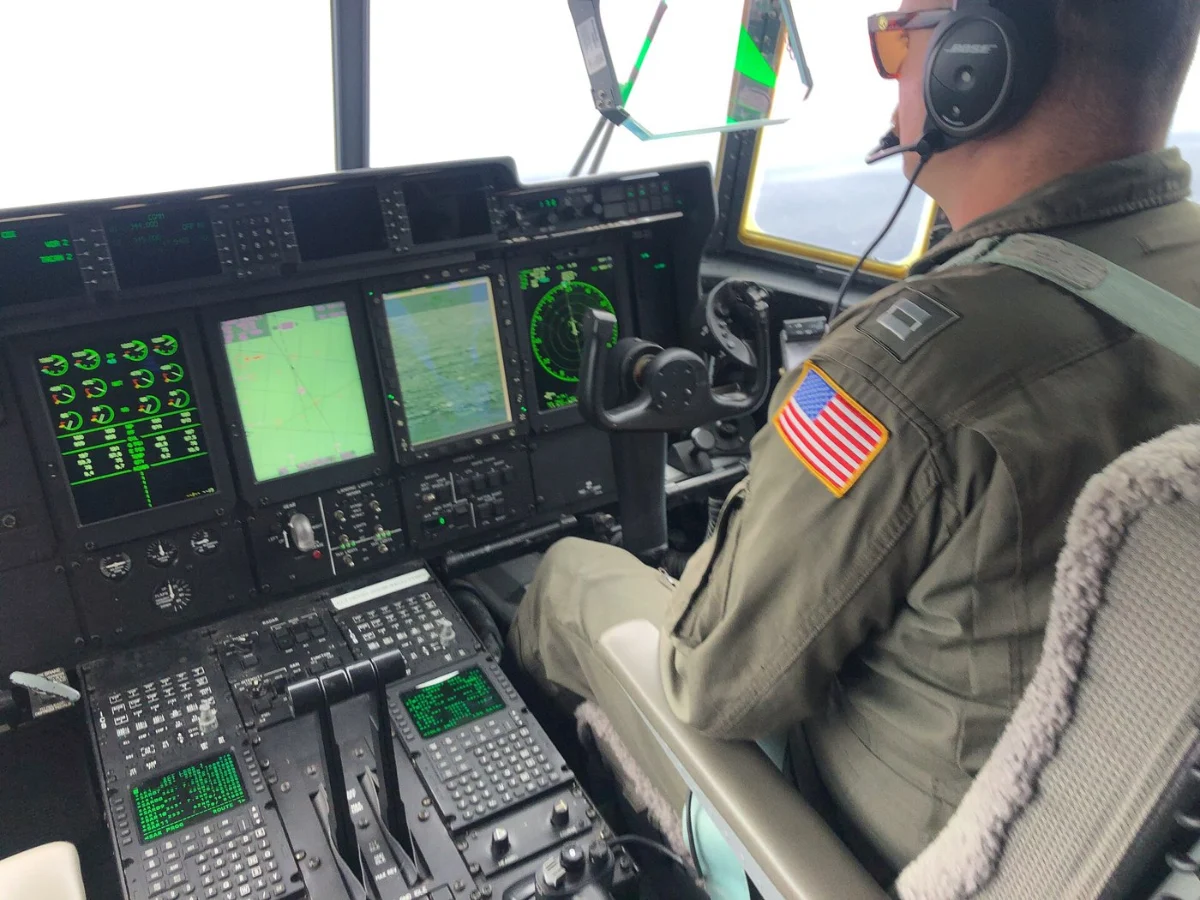 The cockpit of a search aircraft over the sea, with its crew at the controls.