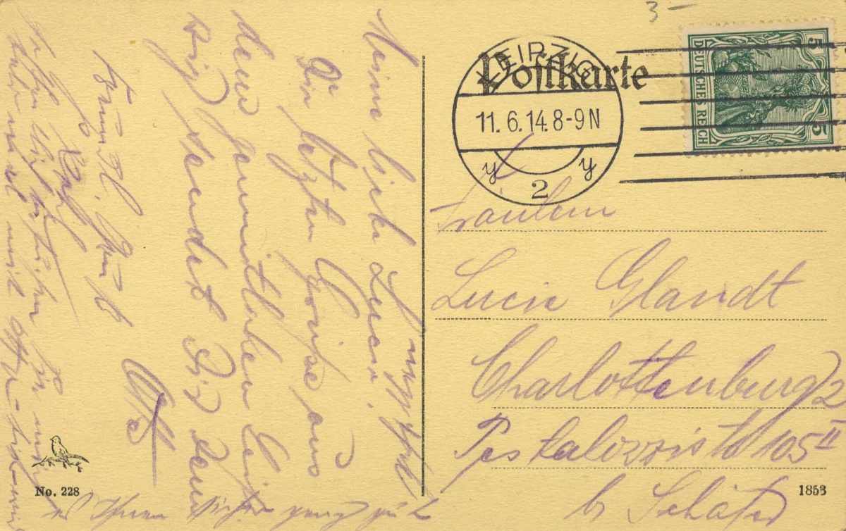 The back of a postcard with a handwritten message in violet ink, a round postmark reading 11.6.14 and a green German stamp.