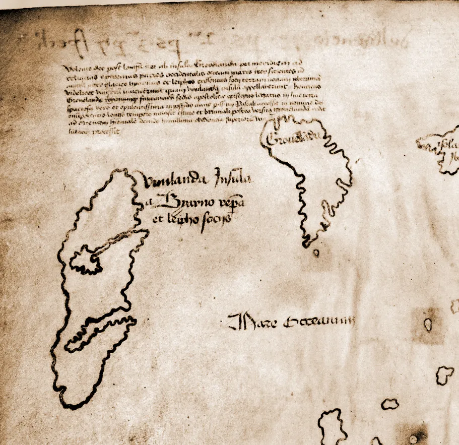 Detail of the map's upper left corner: the long Latin legend in small script, Greenland, and the island of Vinland with two deep inlets and its label.